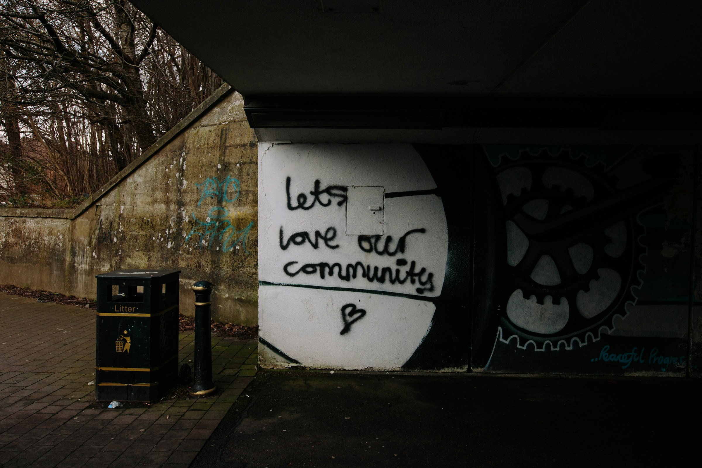 Graffiti on a wall in Cardiff that says lets love our community. By Mike Erskine